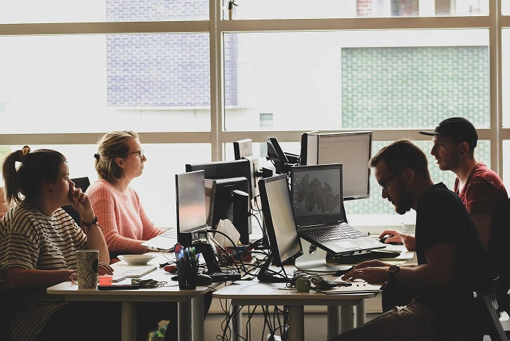 A small team working together at desks.
